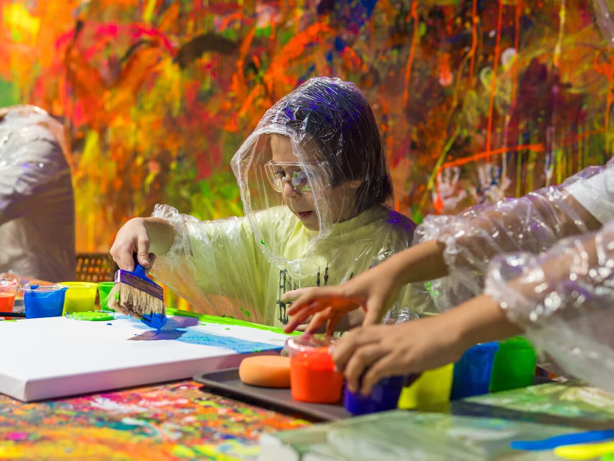 Kid painting on canvas at The Paint Corner Kuwait