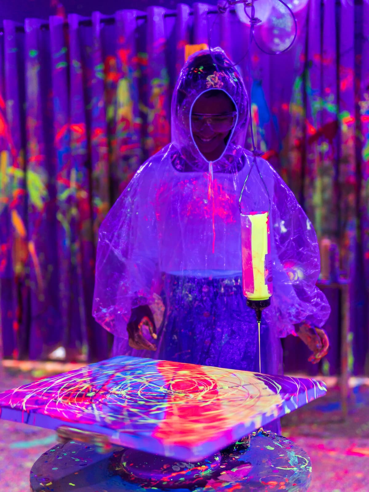 Spin art station glowing under UV lights
