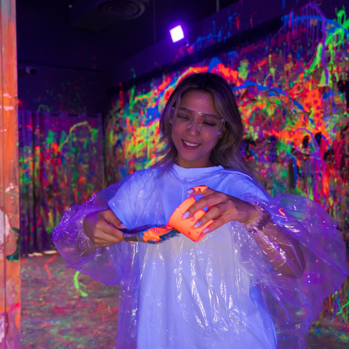 Guest smiling during a paint session at The Paint Corner