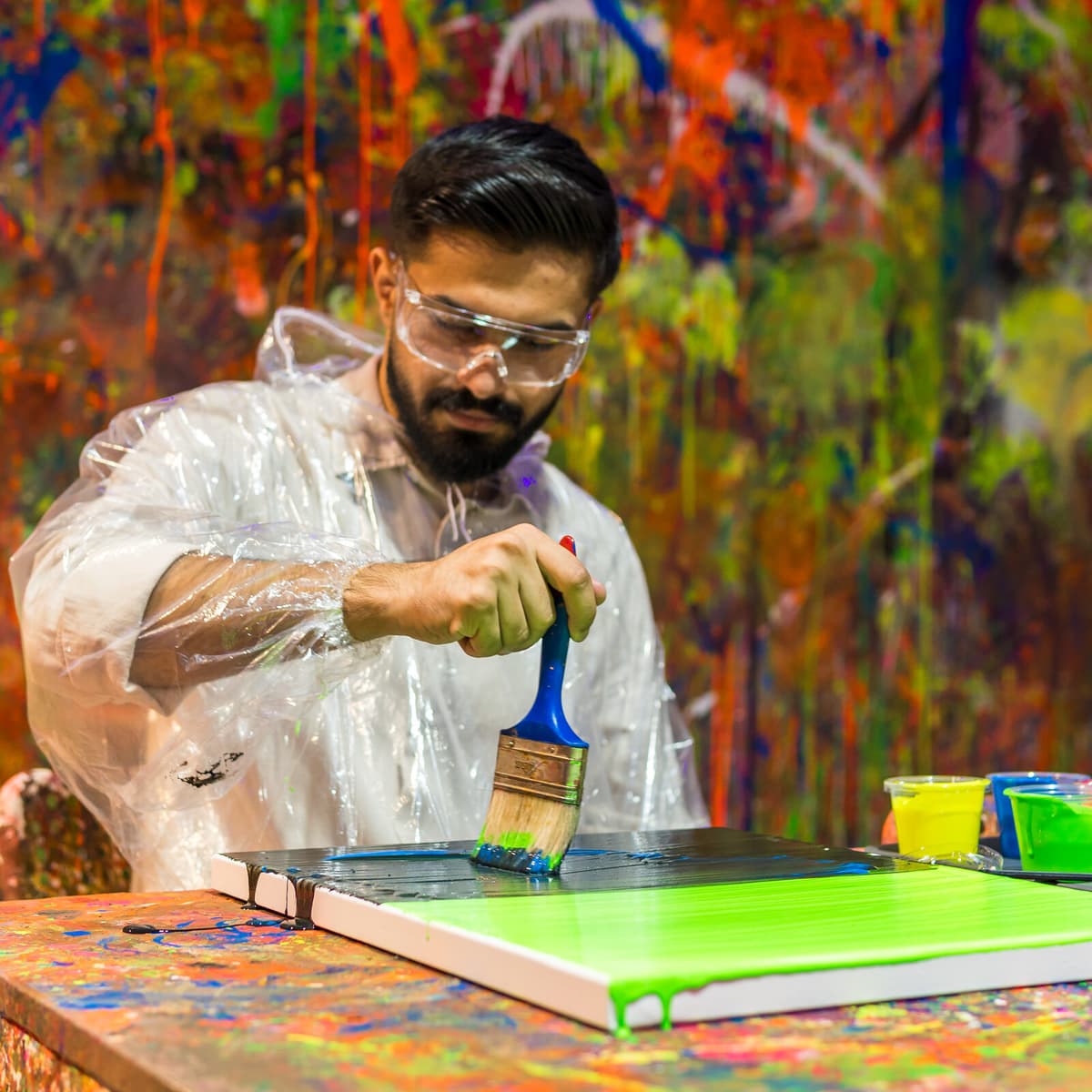 Man creating splat art with a brush in Kuwait