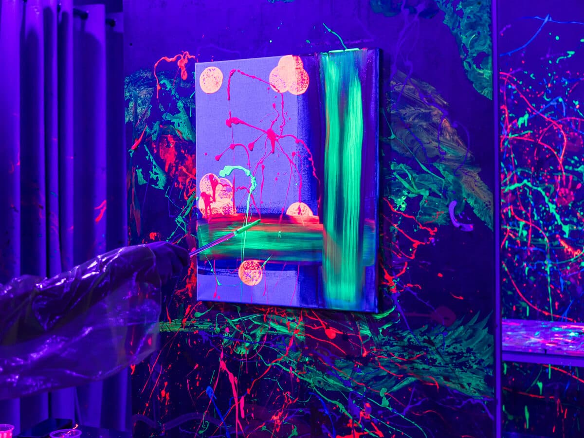 UV neon canvas artwork glowing under blacklight